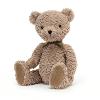 peluche ours brun clair se tenant assis sagement